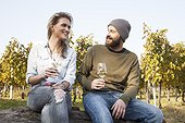 Couple drinking white wine on garden party in vineyard