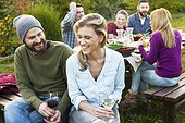 Group of friends drinking wine on garden party