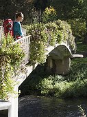 Woman on hiking tour in the Northern Black Forest, crossing bridge near Bad Liebenzell, Baden-Württemberg, Germany