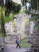 Woman on hiking tour in the Northern Black Forest, crossing ruins of castle of Zavelstein, Bad Teinach-Zavelstein, Baden-Württemberg, Germany