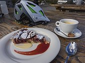 Outdoor restaurant table with coffee cup and pastry, Ferme Auberge Seestadle, France