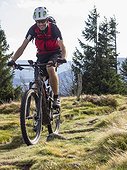 Mountain biker cycling on single trail on Ringelbuhlkopf, Alsace, France