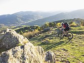 Mountain biker cycling on single trail near the commune of Munster, France
