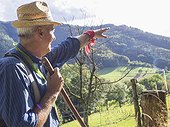 Senior man pointing towards mountain in Middle Black Forest, Baden-Württemberg, Germany
