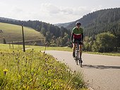 Man riding racing bicycle on cycling tour in the Middle Black Forest, Germany