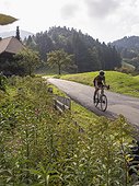 Man riding racing bicycle on cycling tour in the Southern Black Forest, Baden-Württemberg, Germany