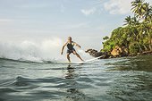 Man surfboarding in the Indian ocean, Sri Lanka