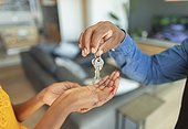 Close up man giving house keys to woman