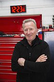 Portrait confident male mechanic in auto repair shop