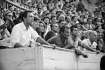 Roger-Viollet | 232729 | Maurice Ronet, Anouk Aimée and Daniel Gélin, French actors, attending a bullfighting. Arles (Bouches-du-Rhône), 1958. | © Bernard Lipnitzki / Roger-Viollet