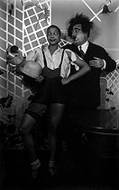 Roger-Viollet | 345340 | Paul Poiret (1879-1944), French fashion designer, and Joséphine Baker (1906-1975), American variety artist. Celebration of Sainte-Catherine at Poiret's house. Paris, on November 25, 1925. | © Boris Lipnitzki / Roger-Viollet