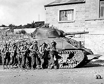 Roger-Viollet | 497369 | World War II. Yanks of 60th inf. regt advance into a Belgian town under the protection of a heavy tank. September 9, 1944. | © US National Archives / Roger-Viollet