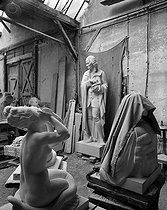 Roger-Viollet | 508161 | World War II. German occupation. Statues in a warehouse. At the centre, statue of Voltaire (1694-1778), French writer, nowadays in the Champion park (VIth arrondissement). Paris, 1941. | © Pierre Jahan / Roger-Viollet