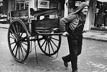 Roger-Viollet | 512981 | Man delivering coal with a handcart, rue du Faubourg du Temple. Paris (Xth arrondissement), 1972. Photograph by Léon Claude Vénézia (1941-2013). | © Léon Claude Vénézia / Roger-Viollet