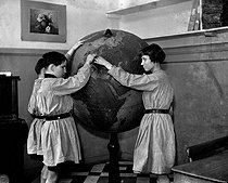 Roger-Viollet | 548653 | Young blind persons learning geography on a globe in relief. Saint-Mandé (Val-de-Marne), 1942. | © LAPI / Roger-Viollet