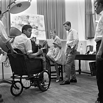 Roger-Viollet | 746519 | Shooting of  A bout de souffle , film by Jean-Luc Godard (1960). Jean Seberg and Jean-Paul Belmondo. On the left : Raoul Coutard. France, September 1959. | © Alain Adler / Roger-Viollet