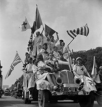Roger-Viollet | 840788 | World War II. Liberation of Paris. Victory parade on the Champs-Elysées. Car of the Red Cross. Paris (VIIIth arrondissement), on August 26, 1944. Photograph by Jean Roubier (1896-1981). | © Fonds Jean Roubier / Roger-Viollet