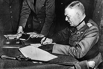 Roger-Viollet | 844732 | World War II. German Marshal Wilhelm Keitel signing the unconditional surrender of Germany. Berlin military academy (Germany), on May 9, 1945. | © Neurdein / Roger-Viollet