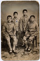 Roger-Viollet | 891674 | Missak Manouchian (sitting on the left, 1906-1944), Armenian poet and resistance fighter, with his brother, Karapet Manouchian (his right hand on his shoulder), at the orphanage. | © Archives Manouchian / Roger-Viollet