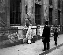Roger-Viollet | 1061305 | Man sticking up election posters, rue de Mézières. Paris (VIth arrondissement), on May 8, 1898. Photo: Ernest Roger. | © Ernest Roger / Roger-Viollet