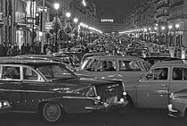 Roger-Viollet | 1380428 | Traffic at night on the boulevards within the city. Paris (Ist arrondissement), on December 18th, 1966. Photograph by Claude Champinot (born in 1932), from the collections of the French newspaper  France-Soir.  Bibliothèque historique de la Ville de Paris. | © Champinot, Claude / Fonds France-Soir / BHVP / Roger-Viollet