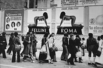 Roger-Viollet | 1383350 | Demonstration against Mother's Day, compulsory motherhood and the abortion ban. Demonstrators walk in front of a poster of Federico Fellini's film  Roma . Paris (France), June 28, 1972. Photograph by Catherine Deudon. | © Catherine Deudon / Roger-Viollet
